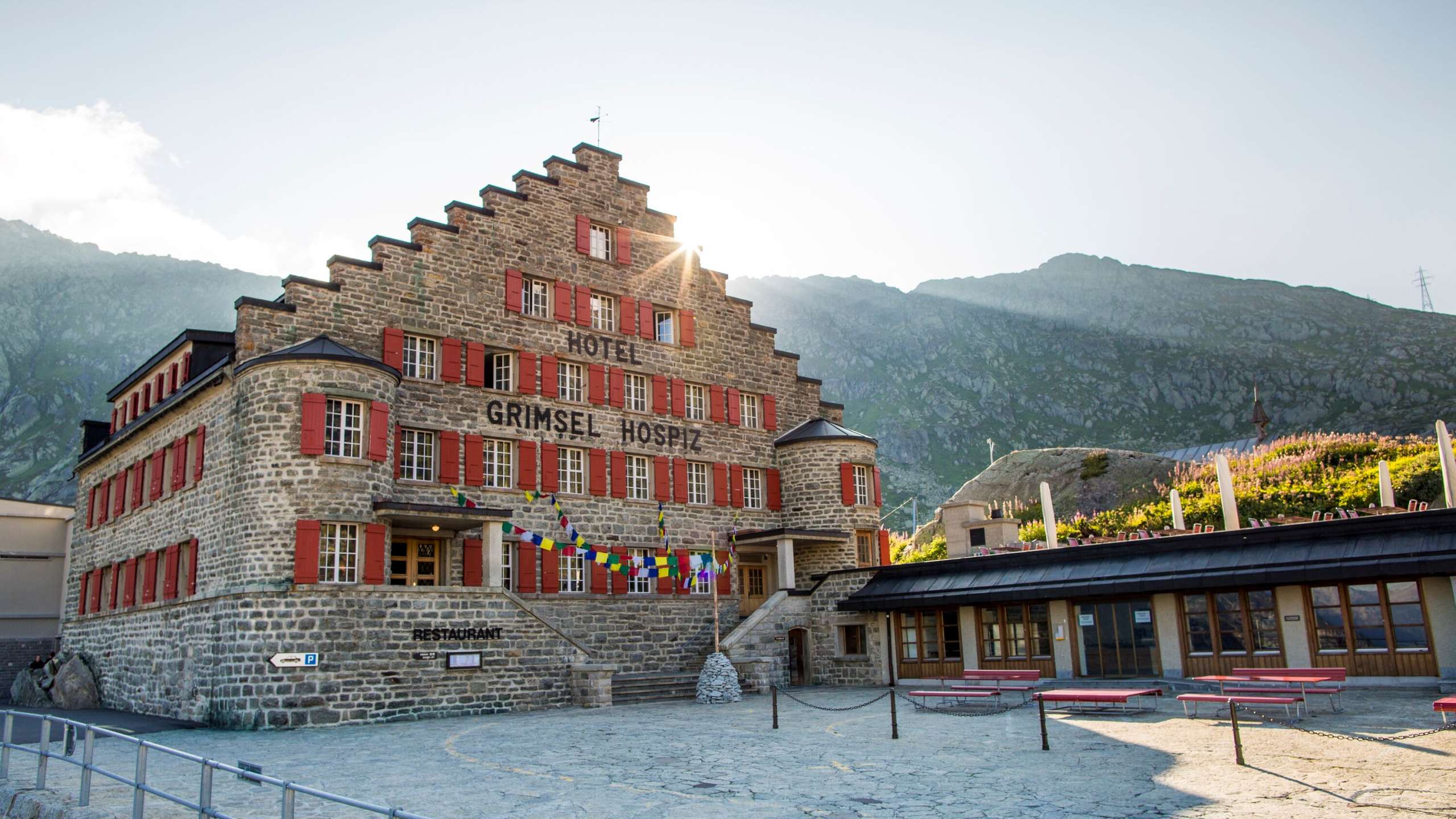 The sun shines out from behind the Grimsel Hospiz Hotel.