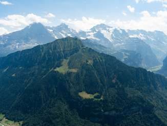 View of the Grüner Männlicher and, in the background, the summer trio of the Eiger, Mönch, and Jungfrau